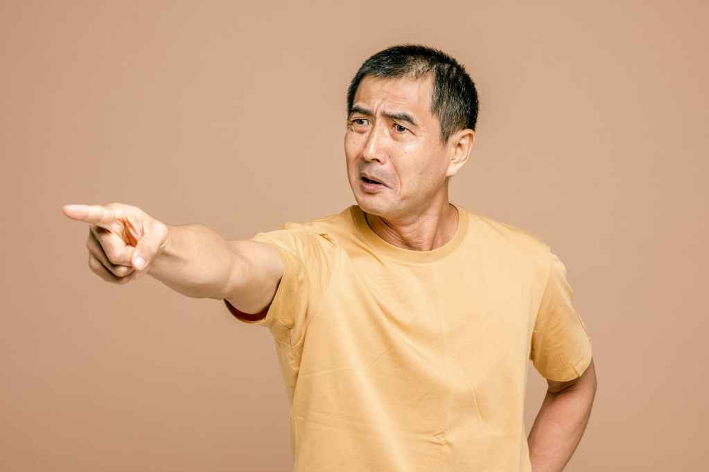 man in yellow crew neck t shirt pointing a finger