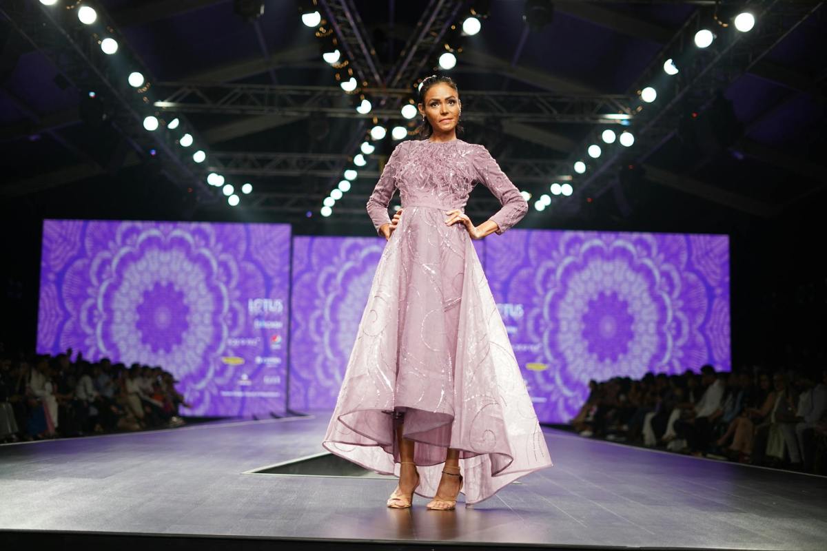 a model in an elegant purple dress