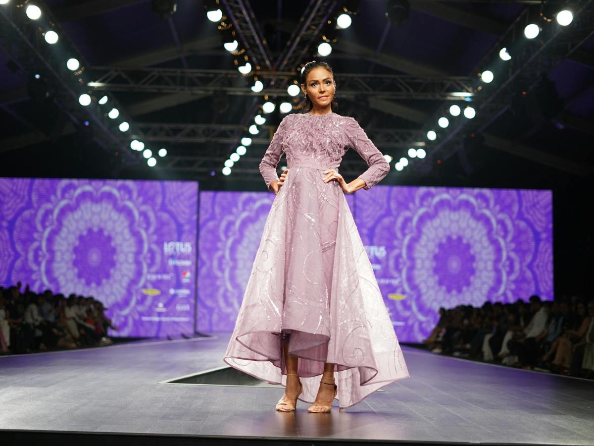 a model in an elegant purple dress