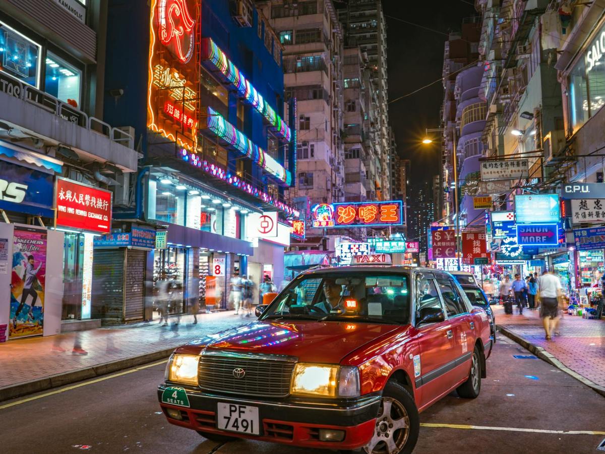 photo of a red taxi on a street