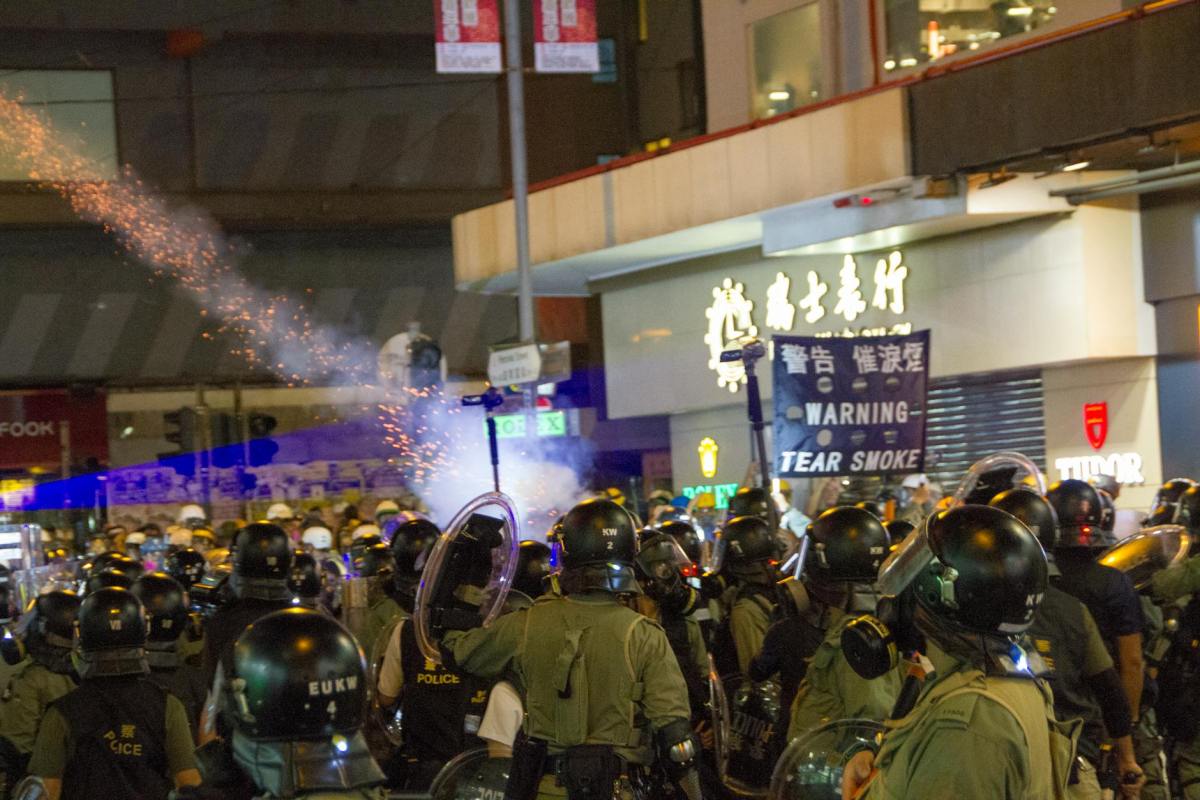 rally in the street with soldiers wearing black helmets