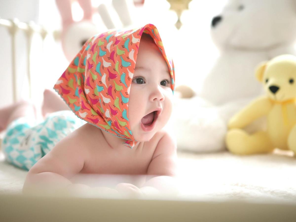 toddler wearing head scarf in bed