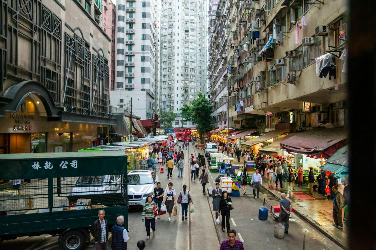 a street in the middle of a market hongkong