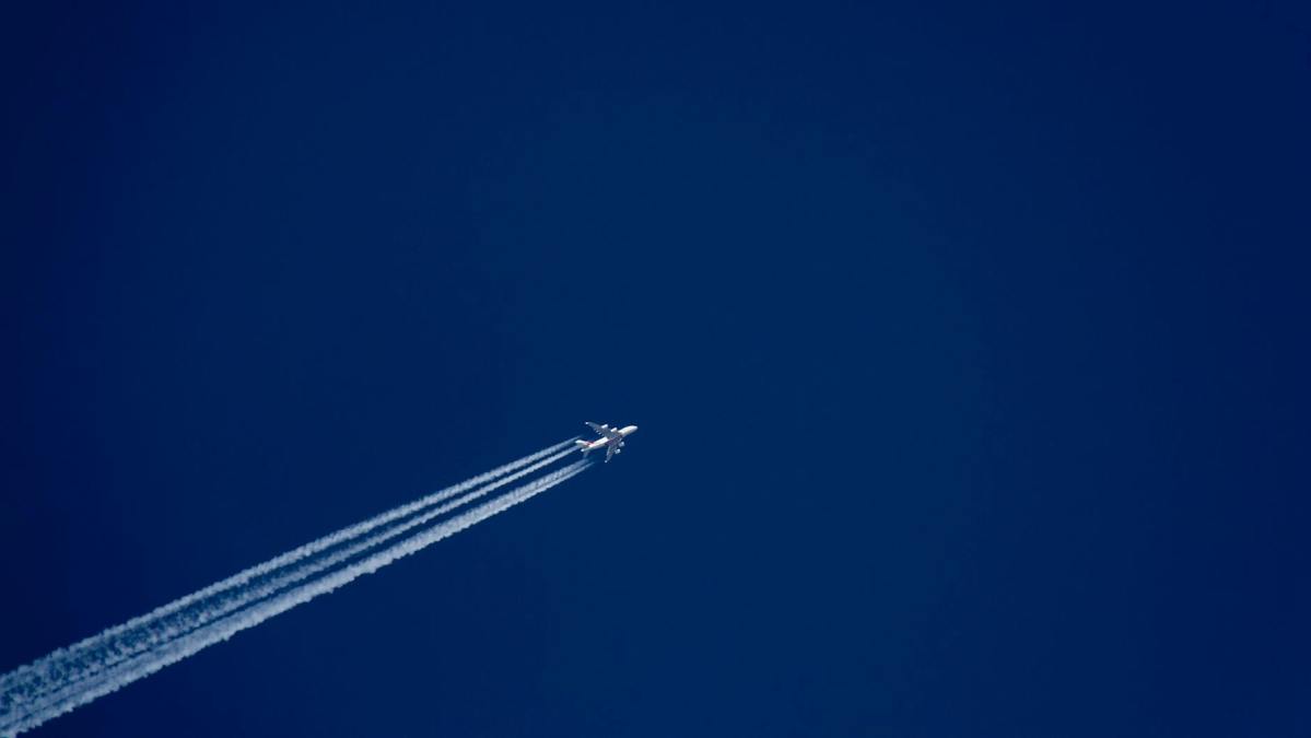 white plane on blue sky