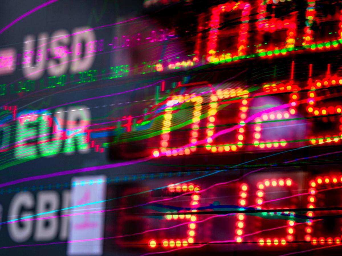 a close up shot of numbers and stock charts