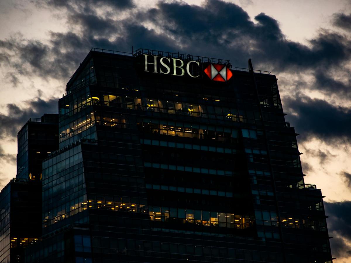 facade of a modern bank building in city at sunset