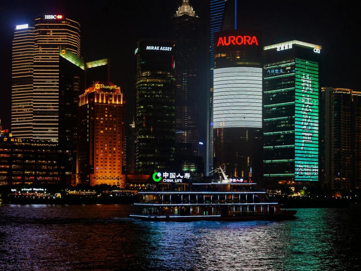 modern skyscrapers near river in city at night