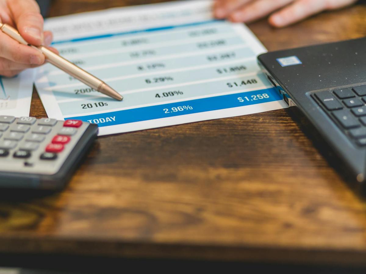 a close up shot of an agent pointing rates with a ballpen
