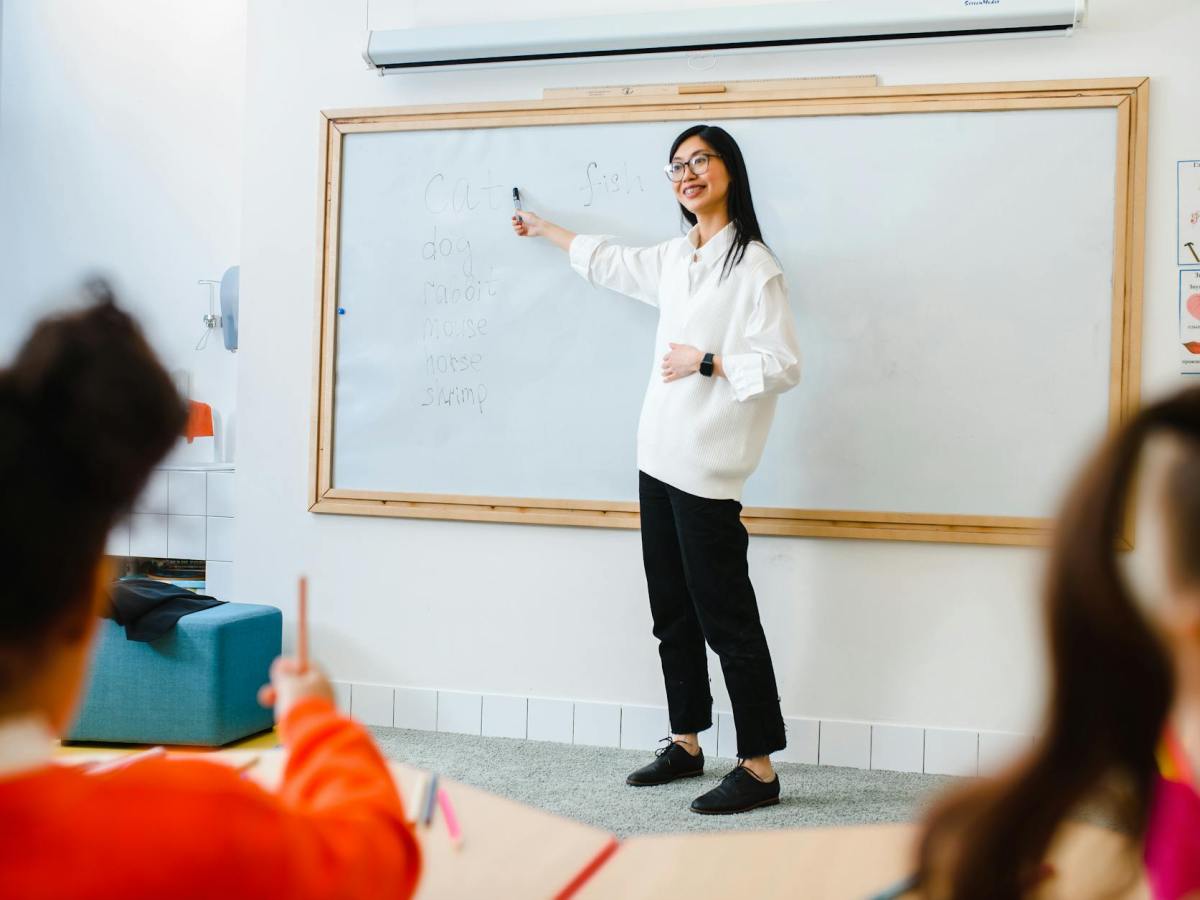 a woman teaching in front of the class