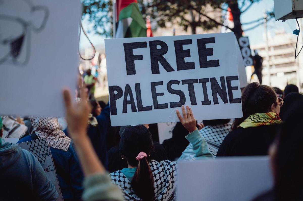 people holding banners at pro palestine rally