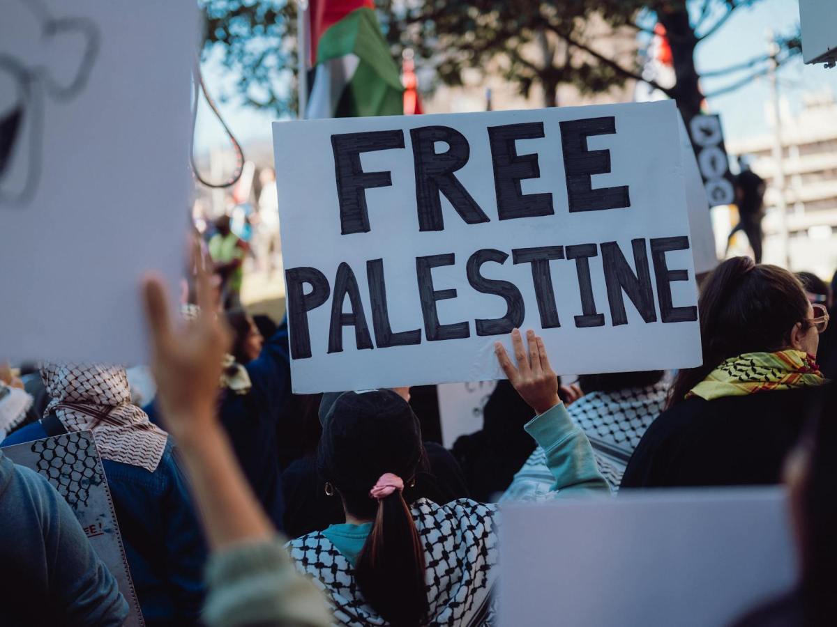 people holding banners at pro palestine rally