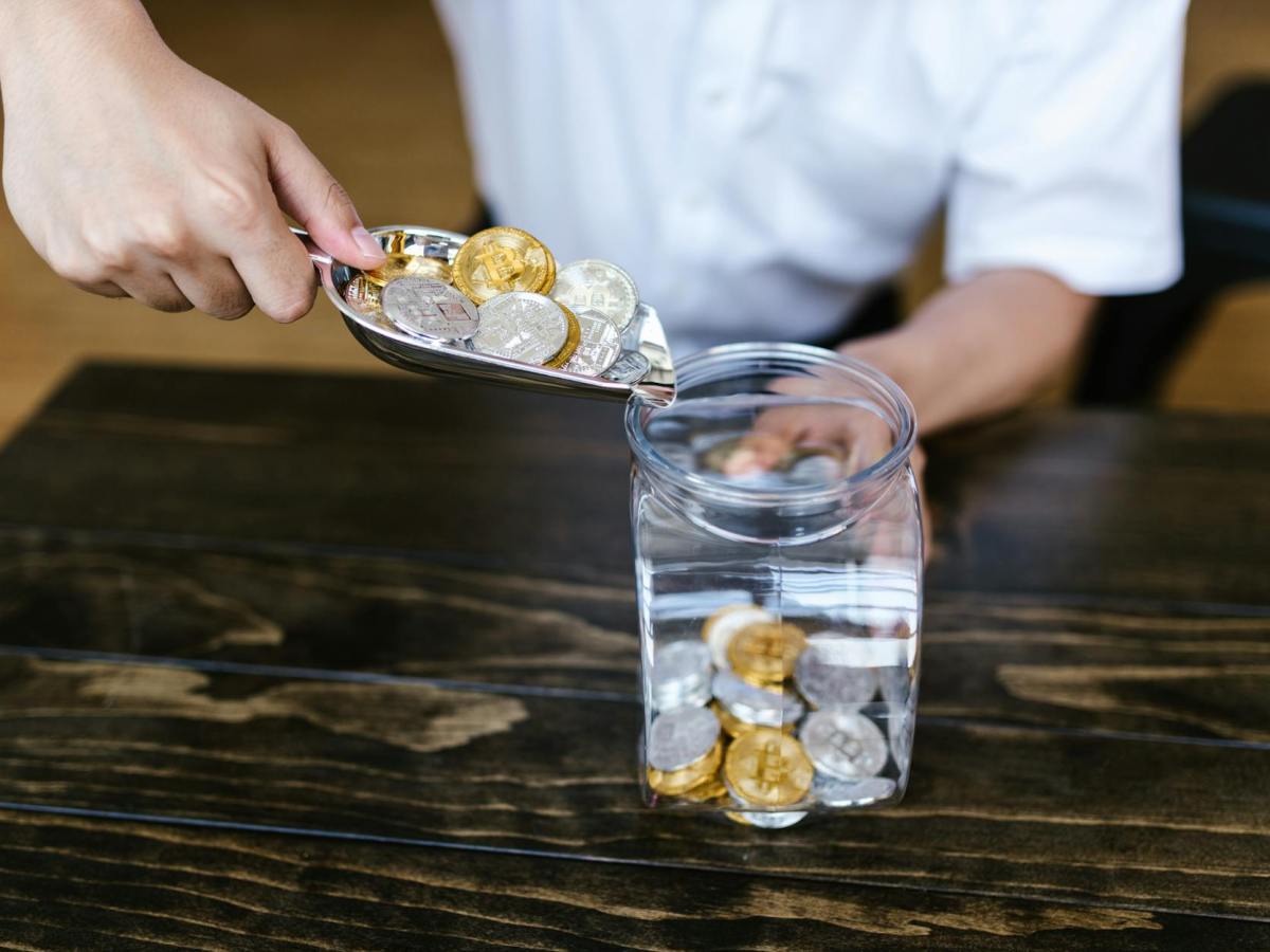 putting coins in a container using a silver small shovel