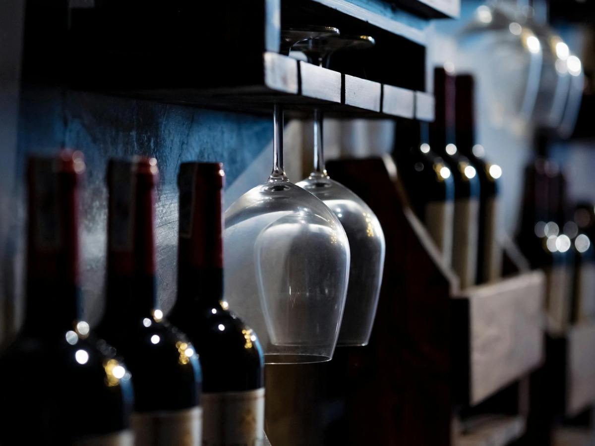 wine glasses and bottles on wooden shelves