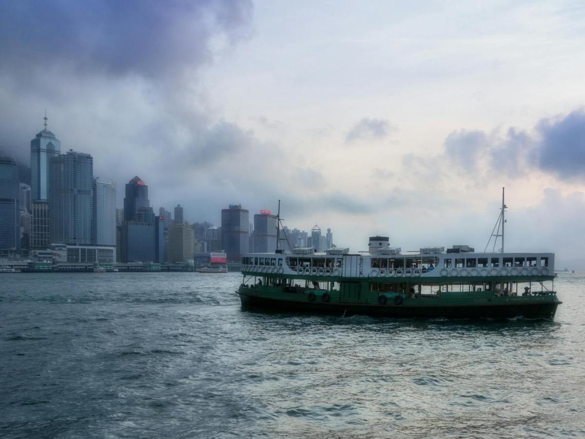 barge on body of water near high rise buildings
