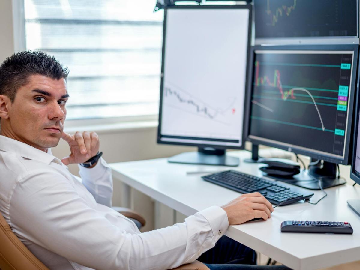 man in white long sleeves shirt sitting in front of a computer