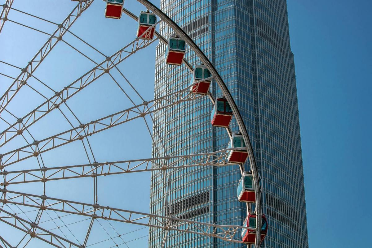 ferris wheel beside the glass building
