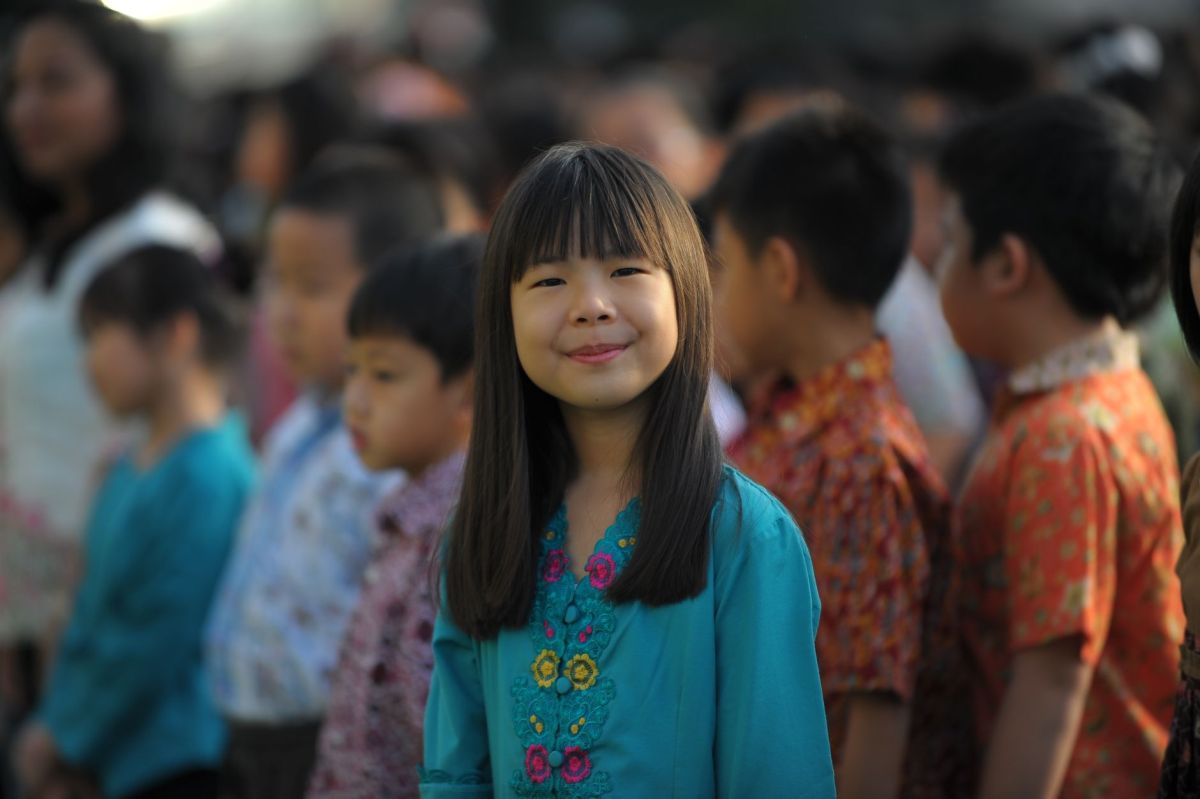 smiling little girl at a school assembly