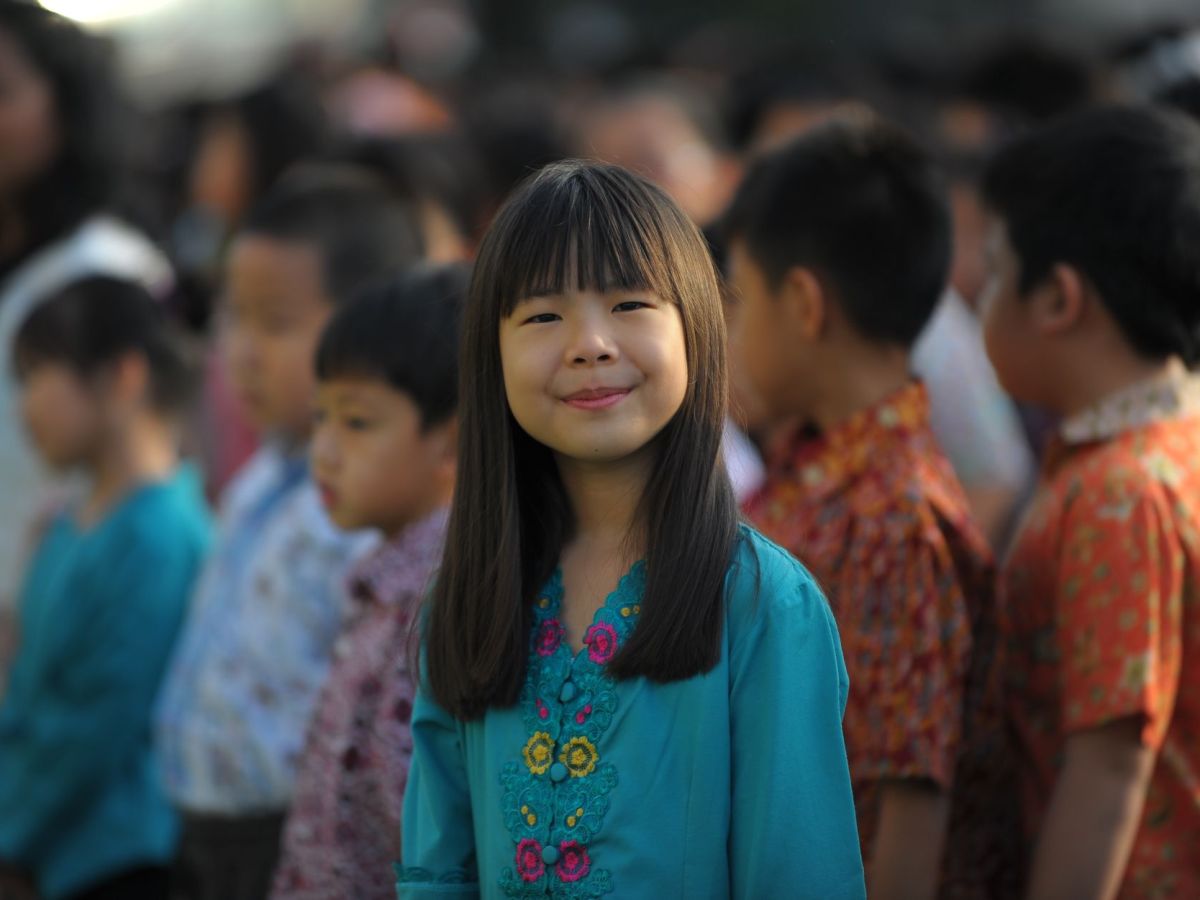 smiling little girl at a school assembly