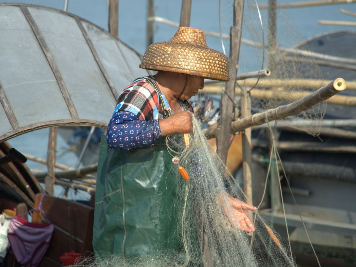 traditional fisherman with net on a boat