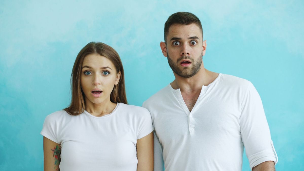 expressive reactions of a surprised couple