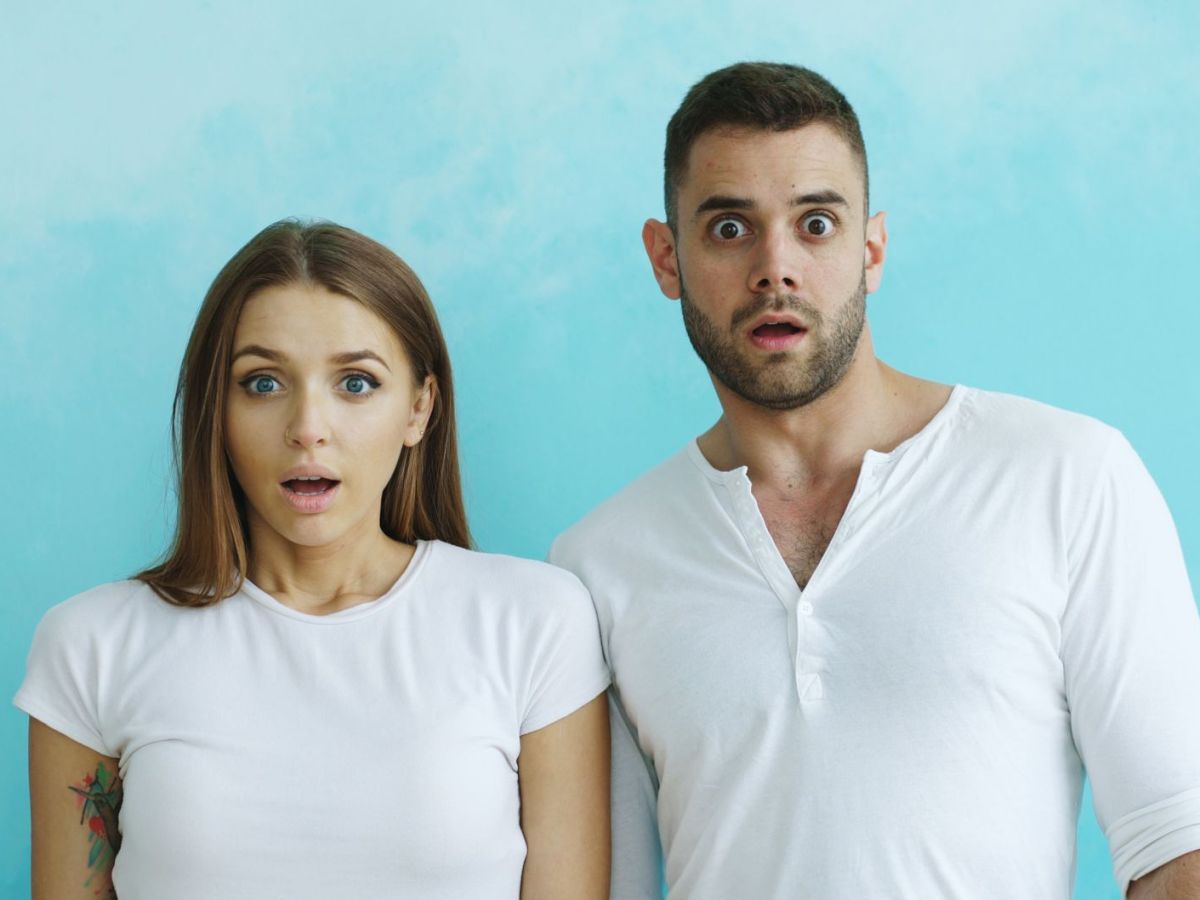 expressive reactions of a surprised couple