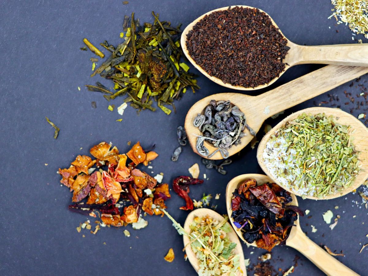 variety of tea blends on wooden spoons