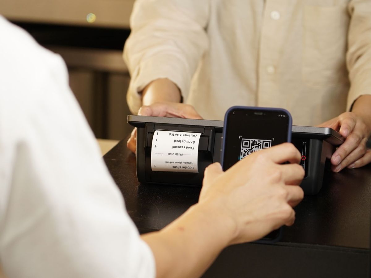 a close up shot of a person scanning a qr code