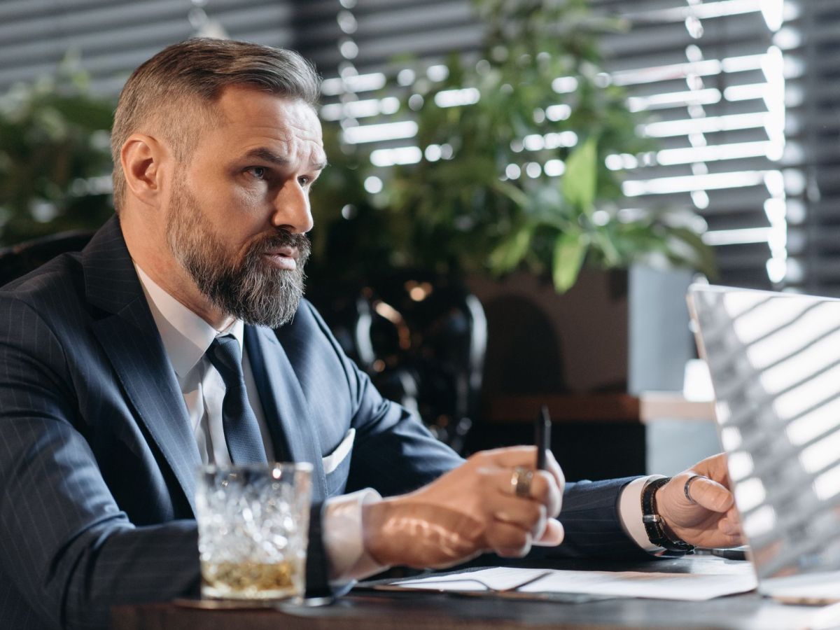 bearded man in a suit at a business meeting