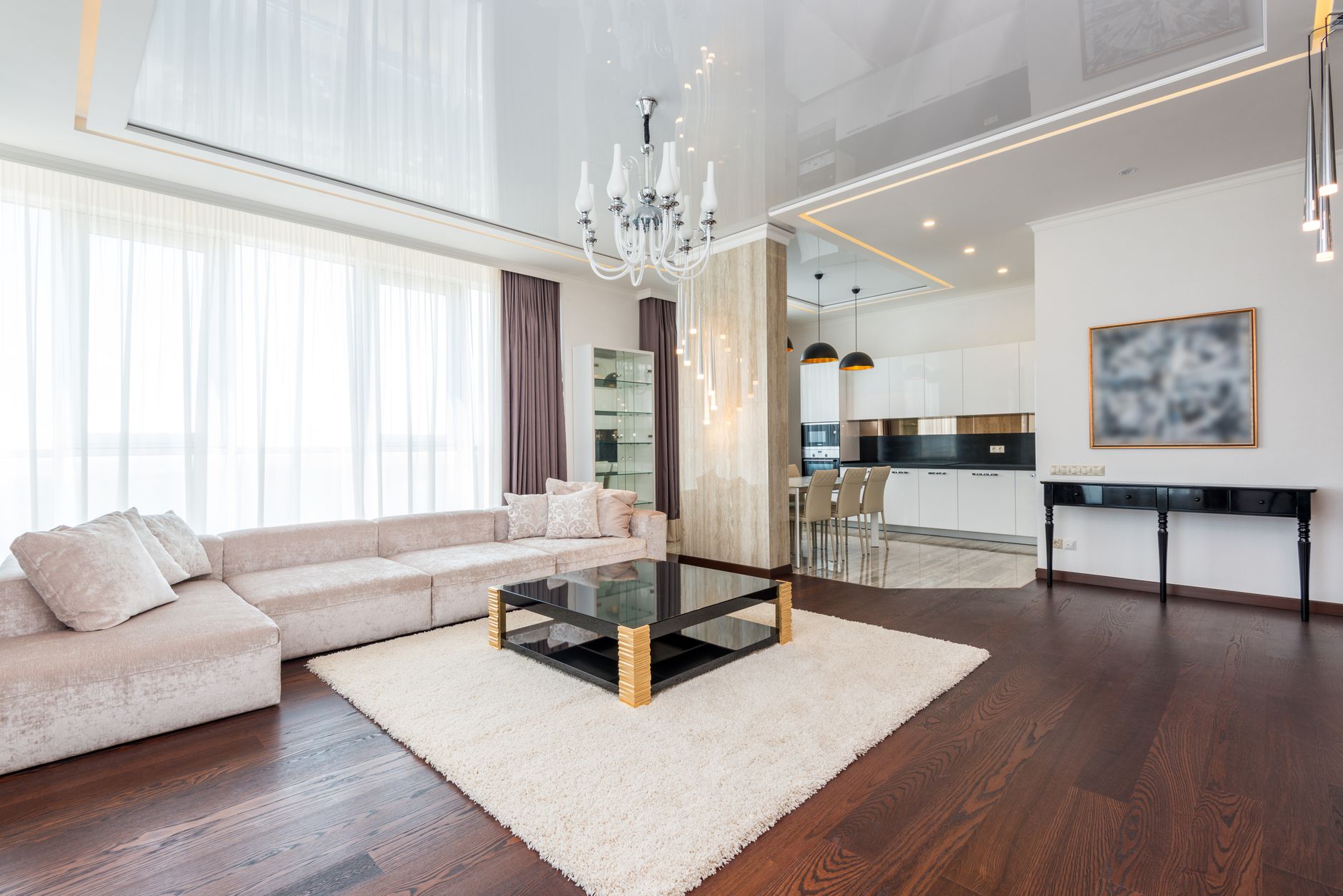 a living room with center table and carpet in the middle